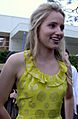 Dianna Agron in a yellow dress, smiling.