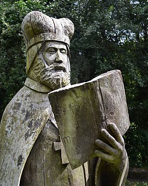 Wooden statue of a man holding a book