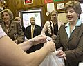 Laura Bush makes a purchase at Franklin Cider Mill in Franklin, Mich., 2006 (cropped1)
