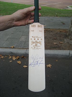 Cricket bat signed by Adam Gilchrist and Kim Highes