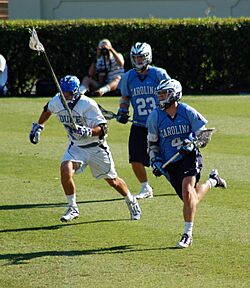 men's lacrosse player running with the ball