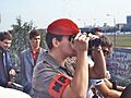 British military police officer looks across Berlin Wall with field glasses, 1984