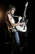 Chrissie Hynde playing guitar onstage