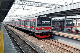 Red electric train at an outdoor station