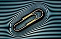Paperclip floating on water (with 'contour lines')