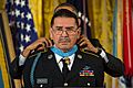 President Barack H. Obama, background, presents a Medal of Honor to former U.S. Army Sgt. Santiago J. Erevia during a ceremony March 18, 2014, in the White House in Washington, D.C. Erevia received the award for 140318-A-KH856-004