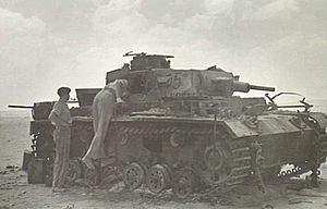 RSG officers inspect destroyed German tank (WWII)