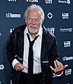 Randy Bachman playing air guitar at the 2024 Toronto International Film Festival (cropped)