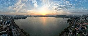 Aerial panorama of West Lake sunset and its lakeside district. December 2023