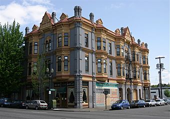 Photograph of a highly ornamented, three-story commercial building on an urban street corner