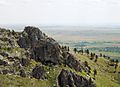 Photograph of the rocky summit of Bear Butte and the view over the Dakota plains.