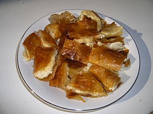 Sliced cheese-filled bougatsa served on a plate