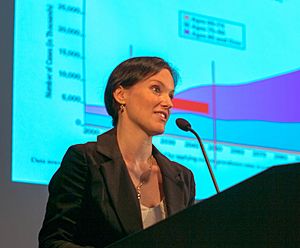 Lisa Mosconi standing behind a podium in front of a slide showing her research