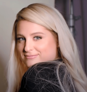 Trainor glancing over her left shoulder towards a camera