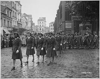 Members of the 6888th Central Postal Directory Battalion take part in a parade ceremony in honor of Joan d'Arc at the marketplace where she was burned at the stake.jpg