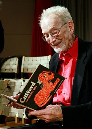 Bridwell in 2011, holding a copy of the first Clifford the Big Red Dog book.