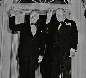Photograph of Winston Churchill flashing his "V for Victory" sign and President Truman waving outside Blair House in... - NARA - 200108 (cropped2)