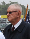 US Navy 090925-N-8721D-037 Capt. Thom Burke, commanding officer of the amphibious command ship USS Blue Ridge (LCC 19) receives a wreath to lay at the U.S. war memorial during a ceremony (cropped).png