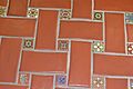 Floor tile at MCW mixing red terra cotta and small decorative tile