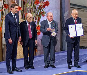 Jørgen Watne Frydnes awarding Terumi Tanaka, Shigemitsu Tanaka, and Toshiyuki Mimaki at 2024 Nobel Peace Prize Ceremony 8 (cropped)