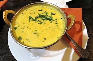 A bowl of soup in a metal bowl