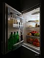 Open refrigerator with food at night