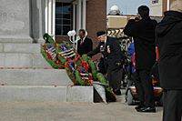 Placing a poppy at the Brampton Cenotaph
