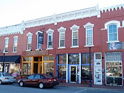 Two-story, red brick building with two distinct store fronts