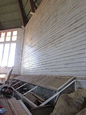 1952 - Narrandera Showground Industrial Hall. Interior, showing glass display cabinet fixed to wall. (5055538b6)