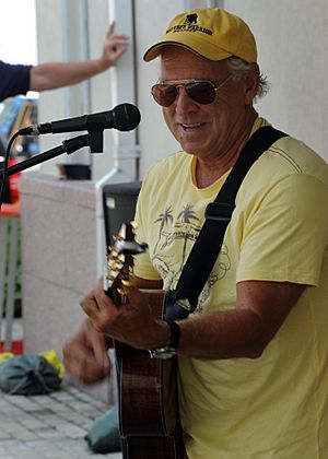 Musician Jimmy Buffet performs for members of Joint Task Force Haiti behind the U.S. Embassy in Port-au-Prince, Haiti, March 3, 2010 100303-N-HX866-001