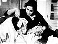 Nargis tends to an injured Sunil Dutt during the filming of Mother India