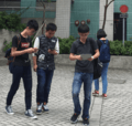 Young people in Hong Kong using smartphones whilst walking
