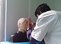 A medical student performs eye examination