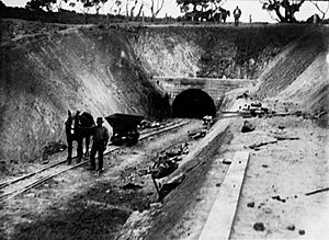 Construction of water culvert through hills - man and horse in foreground(GN03838)