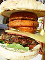 Steak burger with cheese and onion rings