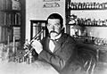 C. J. Pound pictured with his microscope