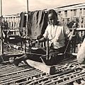 Chakma woman weaving on balcony of bamboo house Chittagong Hill Tracts