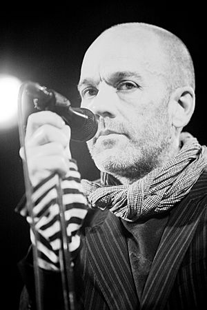 A close-up of Stipe holding a microphone