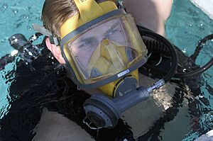 US Navy 050727-N-0295M-010 Electrician's Mate 2nd Class Shane Portton emerges out of the Navy Diver-Explosive Ordnance Disposal (EOD) dive tank exhibit at the 2005 National Scout Jamboree held at Fort A.P. Hill, Va.jpg