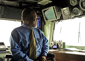 US Navy 101026-N-1531D-021 The Prime Minister of Guyana Samuel Hinds sits in the captain's chair in the bridge aboard the multi-purpose amphibious