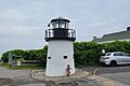 Ada crouching by small Lobster Point Lighthouse