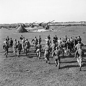 Crews rush to their 3.7-inch guns, 127th Heavy Anti-Aircraft Regiment, Southwold, Suffolk, 9 October 1944. H40434