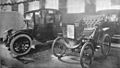 Electric car and antique car on display at 1912 auto show