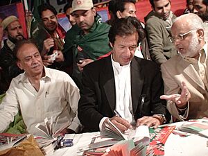 Imran Khan giving autographs