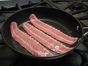 Turkey bacon cooking in skillet