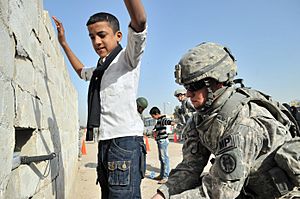 A U.S. Soldier searches an Iraqi boy before allowing him access to the Basra Operations Center during a Medical Civic Assistance Program in Basra, Iraq, March 7, 2011 110307-A-WO967-008