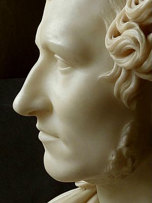 Marble sculpture of clean-shaven man with curly hair
