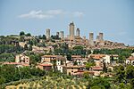 A small town dominated by many tall stone towers