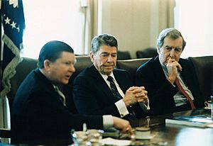 President Ronald Reagan receives the Tower Commission Report with John Tower and Edmund Muskie