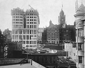 The old County Courthouse, and the Hall of Records, which is under construction, ca. 1920